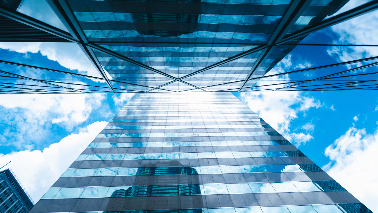 A towering skyscraper against a blue sky